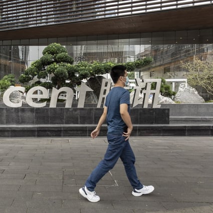 A pedestrian near signage for Tencent Holdings Ltd. at the company's headquarters in Shenzhen, China, on Tuesday, Oct. 12, 2021. Photo: Bloomberg