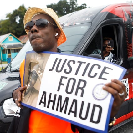 A person holds a sign as protesters demand justice for Ahmaud Arbery in Brunswick, Georgia, on Thursday. Photo: Reuters