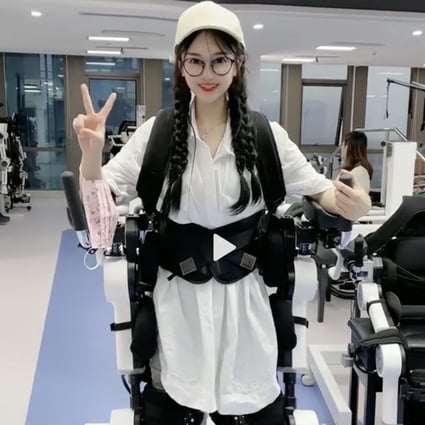Duoduo, a paraplegic poses with an exoskeleton technology that helps her walk. Photo: Weibo