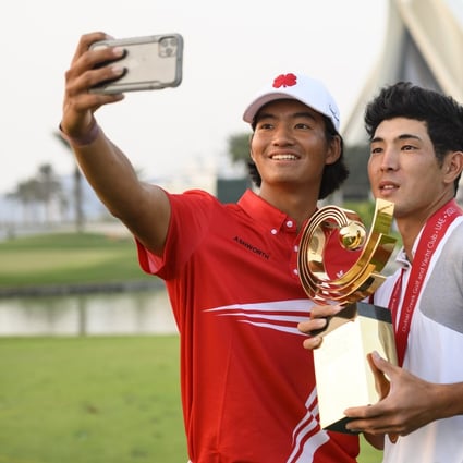 Runner up Taichi Kho of Hong Kong takes a selfie with winner Keita Nakajima of Japan and the AAC trophy after the 2021 Asia-Pacific Amateur Championship at the Dubai Creek Golf and Yacht Club. Photograph: AAC
