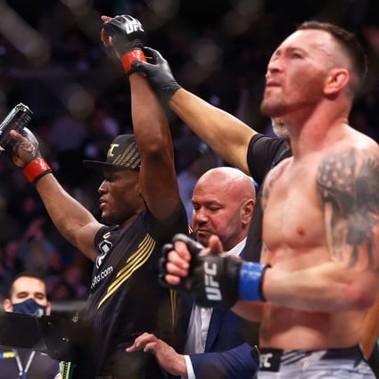 Kamaru Usman celebrates after his decision victory over Colby Covington in their welterweight title bout at UFC 268. Photo: AFP