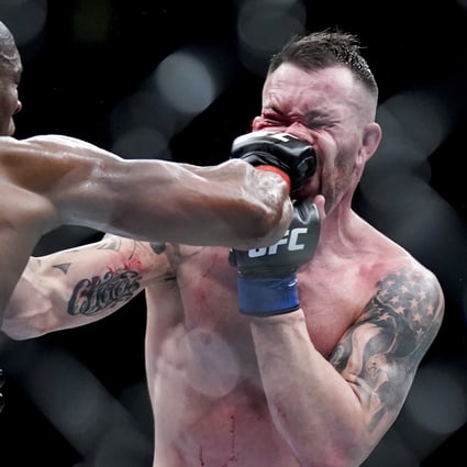 Kamaru Usman lands a punch on Colby Covington’s face during the welterweight title main event at UFC 268. Photo: AP