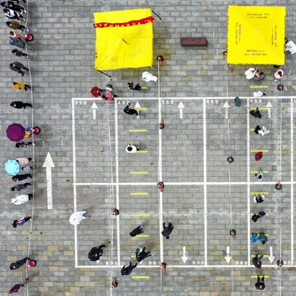 People queue for Covid-19 testing in northwest China, but a leading scientist has said determining antibody levels should be the priority. Photo: Xinhua