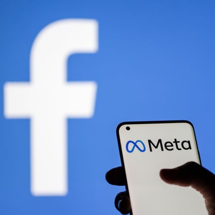 A woman holds a smartphone with Meta logo on it in front of a displayed Facebook logo in this illustration taken October 28, 2021. Photo: Reuters