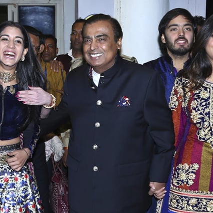 Mukesh Ambani, centre, with his wife and family members in India in 2018. Photo: AP
