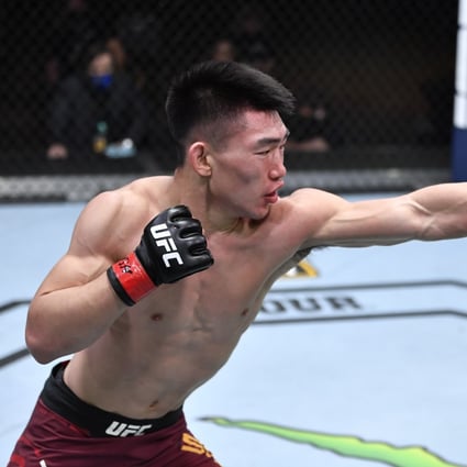 Song Yadong (left) punches Kyler Phillips in their bantamweight fight at UFC 259 in March. Photo: Zuffa LLC