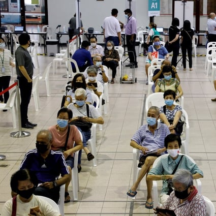 Residents wait at a Covid-19 vaccination centre in Singapore. File photo: Reuters