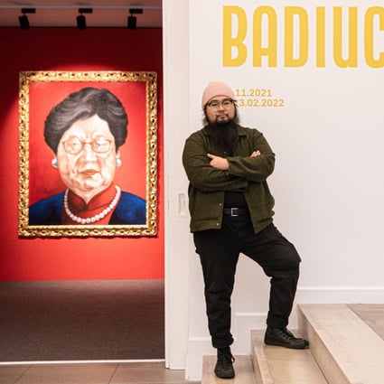 Chinese dissident artist Badiucao poses next to his artwork entitled ‘Carrie Lam, 2018’ at the opening of his exhibition in Brescia, Italy. Photo: AFP