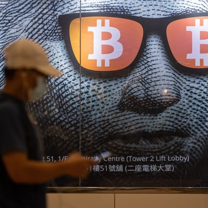 A man walks past an advertising poster for bitcoin and cryptocurrencies in Hong Kong on September 25. Photo: EPA-EFE
