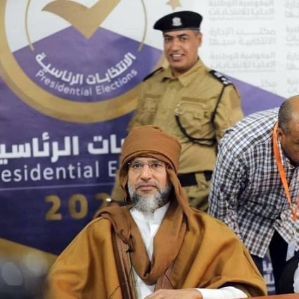 Saif al-Islam Gaddafi, left, son of the former Libyan leader Muammar Gaddafi, registers to run in Libya’s upcoming presidential elections. Photo: EPA-EFE / Libyan Electoral Commission