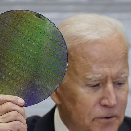 US President Joe Biden holds up a silicon wafer during the CEO Summit on Semiconductor and Supply Chain Resilience at the White House, April 12, 2021. Photo: AP