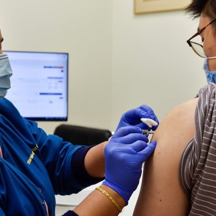 A nurse administers a Covid-19 vaccine to a patient in Singapore earlier this year. Photo: Reuters