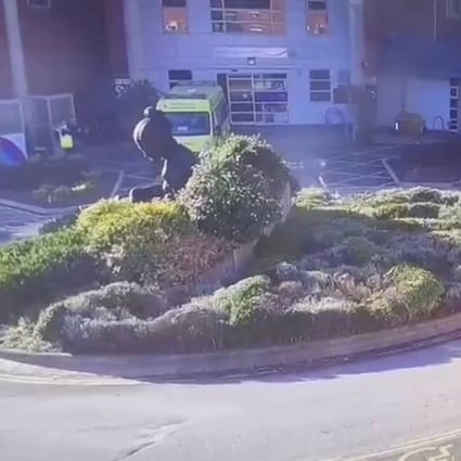 Surveillance camera footage shows a man extinguishing a burning taxi following an explosion outside Liverpool Women's Hospital in Britain on November 14. Photo via Reuters