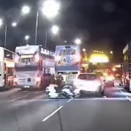 Footage from a dashcam video shows a suspected triad member reversing his car into a police motorbike and then speeding away in Kowloon Bay on Sunday. Photo: Facebook