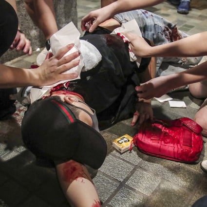 Passers-by attend to an injured man in a bloody mall altercation in 2019, while Hong Kong was in the throes of a social unrest. Photo: Handout