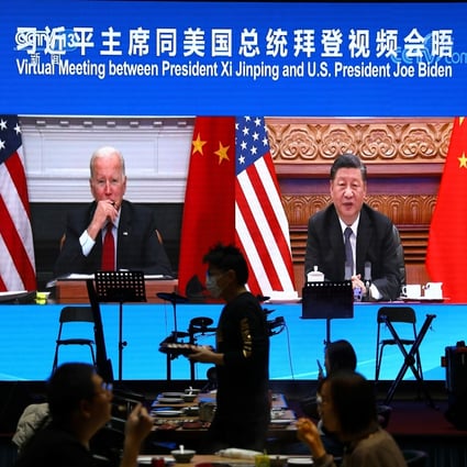 Chinese President Xi Jinping meets US President Joe Biden via video link, as seen at a restaurant in Beijing on November 16. Photo: Reuters