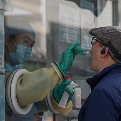 A health worker takes a swab sample at a testing site in Beijing. Authorities are taking no chances in the lead-up to the Winter Games in February. Photo: AFP