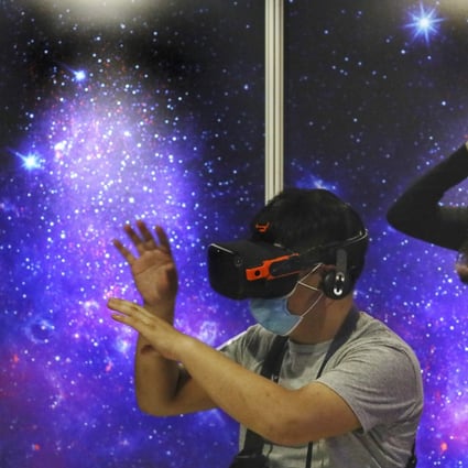 Visitors explore at a virtual reality exhibition at the Hong Kong Space Museum. The metaverse concept has been defined as a shared virtual experience where players interact through digital avatars. Photo: Nora Tam