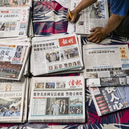 A vendor arranges newspapers for distribution in Hong Kong. Photo: Bloomberg