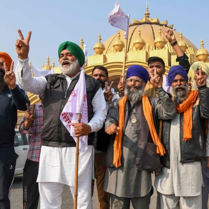 Farmers celebrate after Indian Prime Minister Narendra Modi announced that he will repeal the controversial farm laws in Amritsar on Friday. Photo: AFP