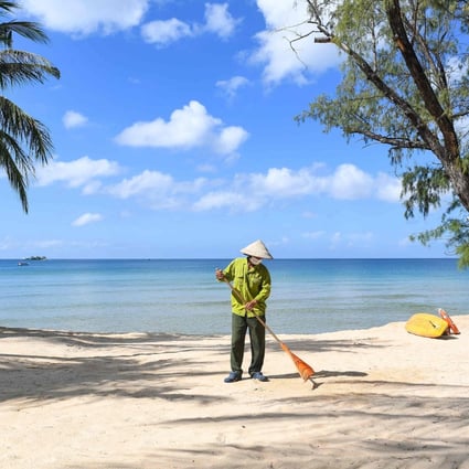 A staff member sweeps the grounds of the Vinpearl resort on Phu Quoc as the island prepares for its first international tourists. Photo: AFP