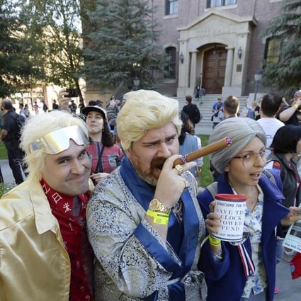 Fans dressed as the characters Dr. Emmett Brown, 1985 rich Biff (C), and as Hill preservation society lady, pose in the Hill Valley Courthouse square in Fillmore, California. Photo: AFP