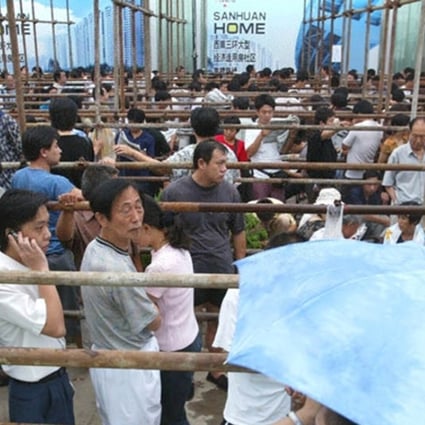 Residents queue to buy low-cost housing units in Beijing, China. Photo: Xinhua