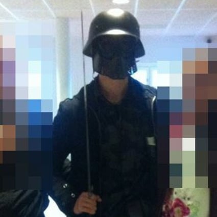 The masked man armed with a sword poses for a photo with two other students before killing two people and wounding two others in Trollhattan, southwestern Sweden. Photo: AFP
