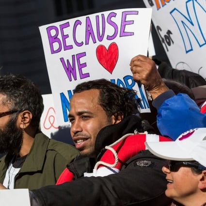 Supporters of Airbnb hold a rally on the steps of New York City Hall showing support for the company. Photo: AFP