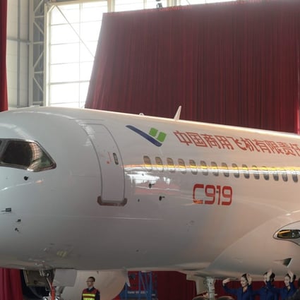 Workers roll out the first C919 passenger jet plane at the state-owned Commercial Aircraft Corporation of China Ltd (COMAC) in Shanghai, China. Photo: EPA