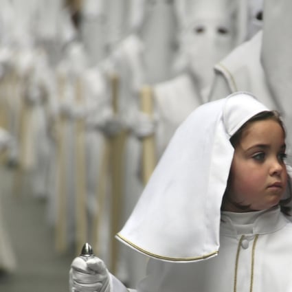 Child takes part in the Holy Week procession in Malaga, southern Spain.
