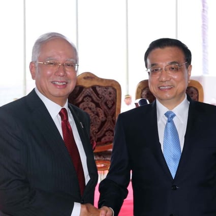 Premier Li Keqiang shakes hands with Malaysian Prime Minister Najib Razak during their talks in Kuala Lumpur on Monday. Photo: Xinhua