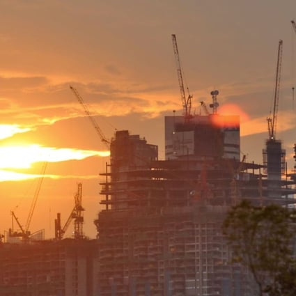 A view shows high-rise office buildings under construction near the business financial district as the sun sets in Singapore . Photo: AFP