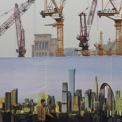 A man walks past a construction site in Beijing. Photo: AP