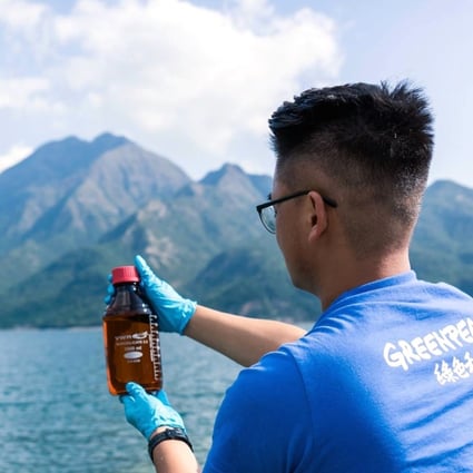 A Greenpeace volunteer takes a sample from one of the reservoirs. Photo: SCMP Pictures