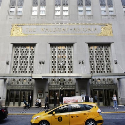 A New York city taxi passes in front of the fabled Waldorf Astoria hotel in New York, which was purchased by a Chinese insurance company as part of an outflow of investment outside the country. Photo: AP