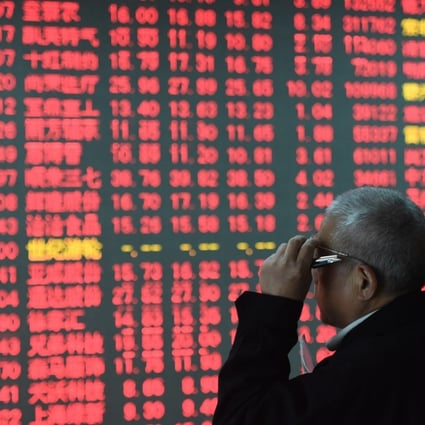 An investor looks through stock information in Hangzhou in China's Zhejiang Province. Chinese developer Future Land recently succeeded in switching its listing to the country’s A-share market from the country’s B-share market. Photo: Xinhua