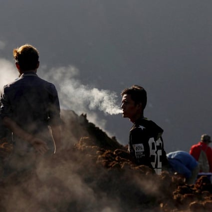 Miners search for jade stones at a mine dump at a Hpakant mine. Photo: Reuters