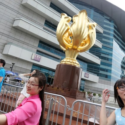 Tourists take selfies at Bauhinia Square in Wan Chai during the “Golden Week” holiday. Photo: SCMP Pictures