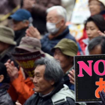 A protester holds a banner saying “No Abe” at a rally in Tokyo this month. Many Japanese oppose new security laws that open the door for Japanese troops to engage in combat overseas for the first time since the end of the second world war. Photo: AFP