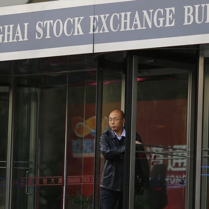 A man walks out of the Shanghai Stock Exchange building at the Pudong financial district in Shanghai in this November 17, 2014 file photo. Hong Kong's stock exchange has told investors it expects them to hit the limit of shares they can buy via its trading link with Shanghai by the end of March 2015, a development that will pressure China to lift the quota to prevent the scheme grinding to a near halt. REUTERS/Carlos Barria/Files (CHINA - Tags: BUSINESS)