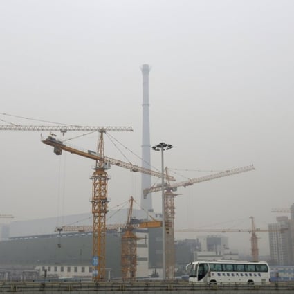 A bus drives past a construction site in Beijing. Photo: Reuters