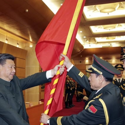 Chinese President Xi Jinping, front left, gives a military flag to Wei Fenghe, commander of the newly formed Rocket Force of the People’s Liberation Army, and Wang Jiasheng, front right, political commissar of the newly formed Rocket Force. Photo: Xinhua