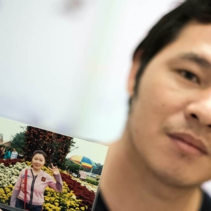 Wu Rongpu holds a picture of his wife Zhu Xiaomei, a labour activist who was arrested in Guangdong. Photo: AFP