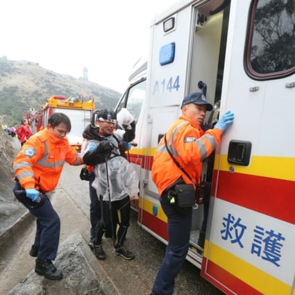 Emergency services assist those in danger of succumbing to hypothermia on Tai Mo Shan this morning. Photo: Felix Wong