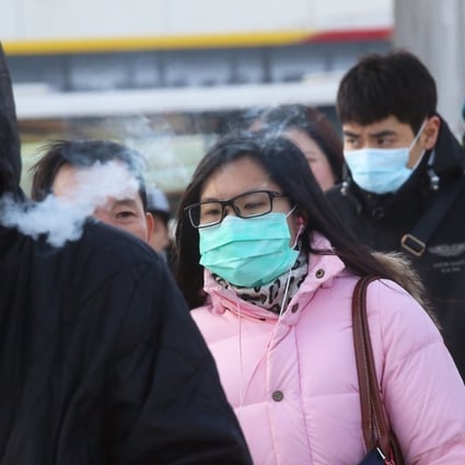 People wearing masks and thick clothes on the coldest Monday of the city in 59 years. Photo: K.Y. Cheng