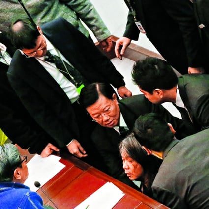 Lawmaker “Long Hair” Leung Kwok-hung is dragged away by security guards during the meeting yesterday. Photo: Edward Wong