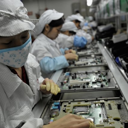 Workers assemble electronic components at a Foxconn factory in Shenzhen. Photo: AFP