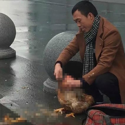 The man killing a chicken outside Wenzhou railway station. Photo: SCMP Pictures