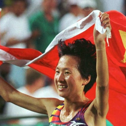 Wang Junxia drapes herself in the Chinese flag after winning the 5,000m race at the 1996 Atlanta Olympics. Photo: Reuters